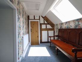 A hallway with a bench and a door at Upper Dolarddyn in Castle Caereinion