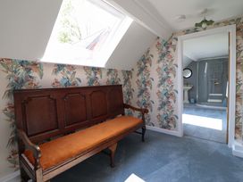 A room with a bench and a bathroom visible in the background at Upper Dolarddyn Castle Caereinion