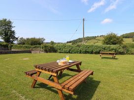 A picnic table with food and drink in the garden at Upper Dolarddyn Castle Caereinion