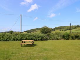 A picnic table on grass at Upper Dolarddyn Castle Caereinion