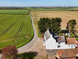 An outdoor view of fields and a house at Bewholme, Skipsea