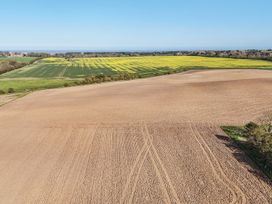 A landscape with fields of crops and flowers at Bewholme in Skipsea