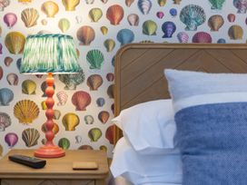 A bedroom with a bed and bedside table at Far Cliffs in St. Ives