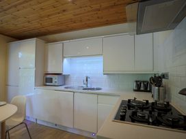A kitchen with a sink and stove at Lodge 68 - Fern Gully near Chudleigh