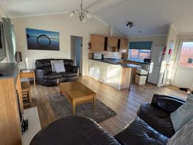 A living room with a sofa and coffee table at Woodland View 31 - The Hawthorns near Chudleigh