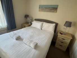 A bedroom with a double bed and two towels at Woodland View 31 - The Hawthorns Finlakes Holiday Park near Chudleigh