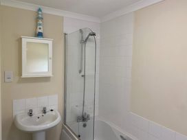 A bathroom with a bathtub, shower, sink and mirror at Woodland View 31 - The Hawthorns near Finlakes Holiday Park