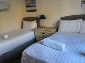 A bedroom with two beds and a nightstand at Woodland View 31 - The Hawthorns Finlakes Holiday Park near Chudleigh