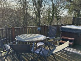 An outdoor seating area with a table and chairs at Woodland View 31 - The Hawthorns Finlakes Holiday Park near Chudleigh