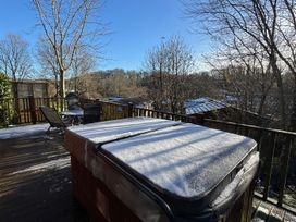 A deck with a hot tub and chairs at Woodland View 31 - The Hawthorns Finlakes Holiday Park near Chudleigh