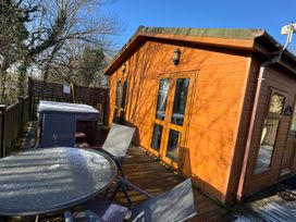 An outdoor area with a hot tub and seating at Woodland View 31 - The Hawthorns near Finlakes Holiday Park