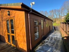 An exterior wooden building with a deck at Woodland View 31 - The Hawthorns Finlakes Holiday Park near Chudleigh