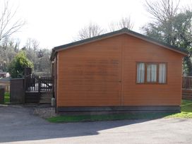 A lodge with a deck and steps located at Woodland View 31 - The Hawthorns, Finlakes Holiday Park near Chudleigh