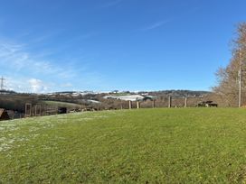A grassy area with trees and tables at Woodland View 31 - The Hawthorns near Finlakes Holiday Park