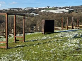 An outdoor area with climbing frames and wall at Woodland View 31 - The Hawthorns near Chudleigh