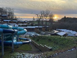 A water slide and cabins with trees at Woodland View 31 - The Hawthorns Finlakes Holiday Park near Chudleigh