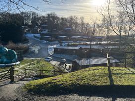 A view of houses and a road with a slide at Woodland View 31 - The Hawthorns near Chudleigh
