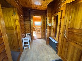 A hallway with wooden features and doors at Tor View near Finlakes Holiday Park near Chudleigh