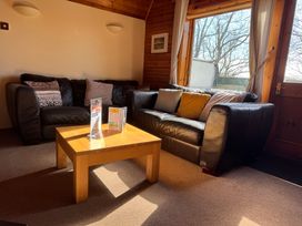 A living room with a sofa and coffee table at Tor View Finlakes Holiday Park near Chudleigh