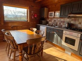 A kitchen with a table and chairs at Tor View Finlakes Holiday Park near Chudleigh