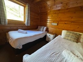 A bedroom with two beds and a window at Tor View Finlakes Holiday Park near Chudleigh