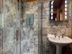 A bathroom with a shower and sink at Tor View Finlakes Holiday Park near Chudleigh
