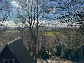 A view of trees and houses near a green field at Tor View Finlakes Holiday Park near Chudleigh