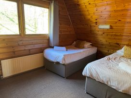 A bedroom with two beds and a window at Tor View Finlakes Holiday Park near Chudleigh