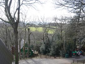 An outdoor view of trees, buildings and a field at Tor View in Finlakes Holiday Park near Chudleigh