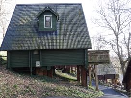 A cabin with a sloped roof and balcony at Tor View in Finlakes Holiday Park near Chudleigh