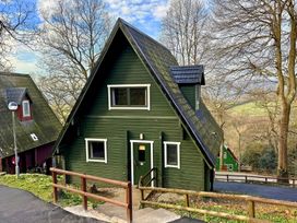 A house with green exterior and a pathway at Tor View, Finlakes Holiday Park near Chudleigh