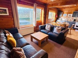 A living room with a sofa and dining area at Tor View Finlakes Holiday Park near Chudleigh
