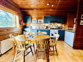 A kitchen with a table and chairs at Tor View, Finlakes Holiday Park near Chudleigh