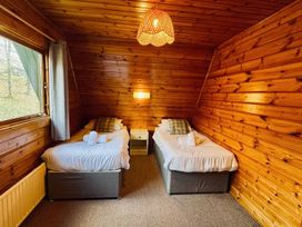 A bedroom with two beds and a window at Tor View Finlakes Holiday Park near Chudleigh