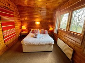 A bedroom with a bed and lamps at Tor View Finlakes Holiday Park near Chudleigh
