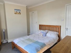 A bedroom with a bed and bedside table at Harbour View in Whitby