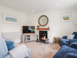 A living room with a television and fireplace at Glendale in Port Isaac