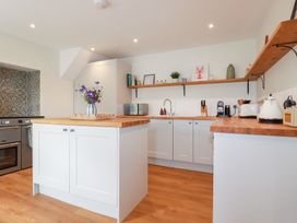 A kitchen with cabinets and appliances at Glendale in Port Isaac