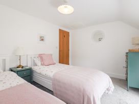 A bedroom with twin beds and a nightstand at Glendale in Port Isaac
