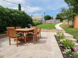 A garden with a dining table and chairs at Glendale, Port Isaac