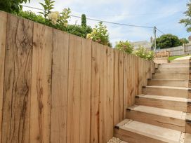 A wooden staircase with a fence and plants at Glendale in Port Isaac