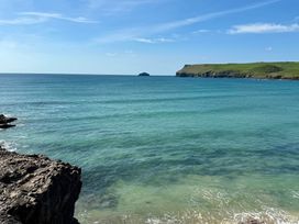 A view of the ocean with rocky shore and distant island at Glendale near Trelights