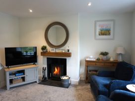 A living room with a fireplace and TV at Glendale Trelights near Port Isaac