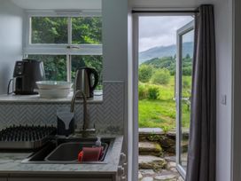 A kitchen with appliances and a view of mountains at 1 Aberbeinw Dolwyddelan