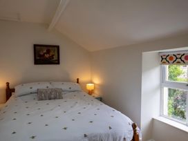 A bedroom with a bed and window at 1 Aberbeinw in Dolwyddelan