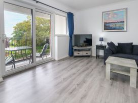 A living room with a sofa and television at The View in Weymouth