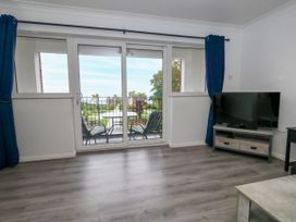 A living room with a sliding door leading to a patio at The View in Weymouth