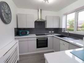 A kitchen with cabinets, sink, oven, microwave, and dishwasher at The View in Weymouth