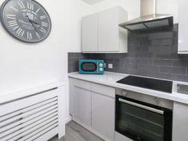 A kitchen with a microwave and oven at The View in Weymouth