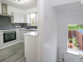 A kitchen with modern cabinets and a window at The View in Weymouth